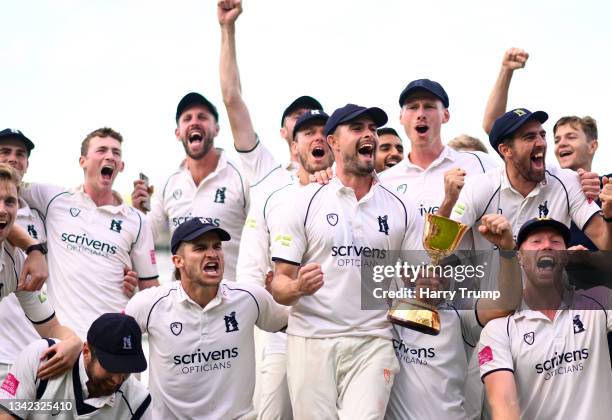 Will Rhodes of Warwickshire lifts the County Championship Trophy following Day Four of the LV= Insurance County Championship match between...