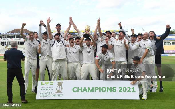 Will Rhodes lifts the trophy as the Warwickshire team celebrate after they won the County Championship after defeating Somerset in the Division One...