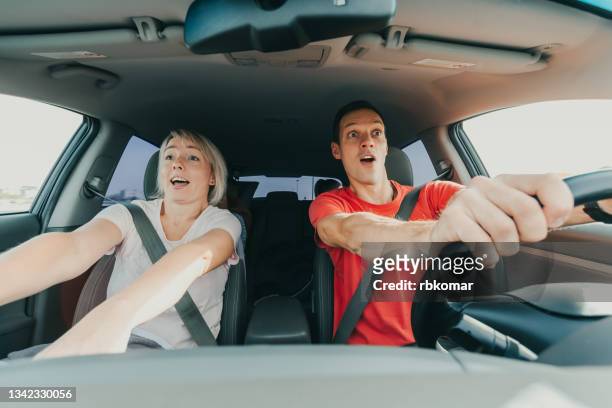 ecstatic young couple rushing car - inner courage stock pictures, royalty-free photos & images
