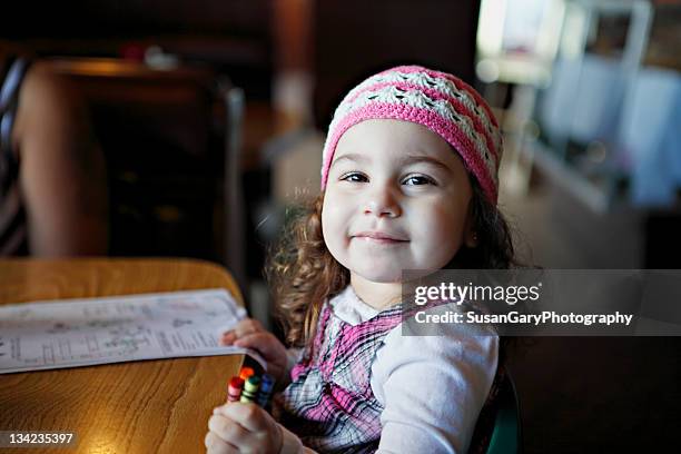 girl holding caryon and looking at camera - kid holding crayons stock pictures, royalty-free photos & images