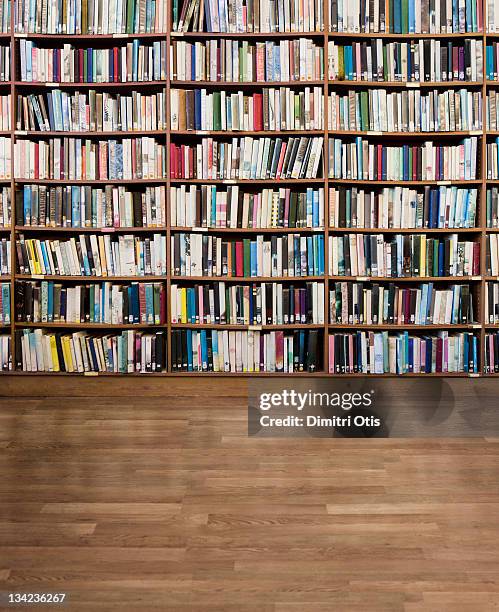 library of books without titles or branding - bücherwand stock-fotos und bilder