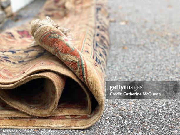 rug removed to check for mold after flood in residential family home - carpet roll stock-fotos und bilder