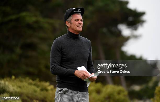 Jesper Parnevik of Sweden checks his card before he hits his tee shot on the fifth hole during the first round of the PURE Insurance Championship at...