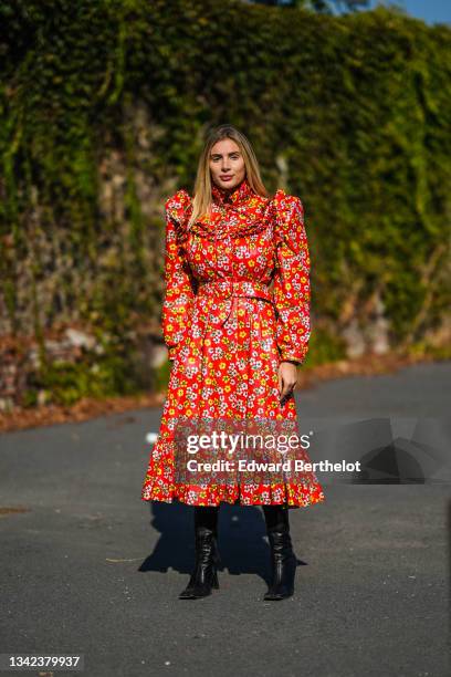 Cristina Musacchio wears a red with pale pink / green / yellow flower print pattern puffy sleeves / shoulder-pads / turtleneck / belted pleated...