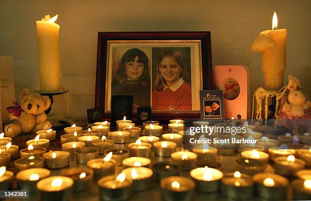 Candles are lit in remembrance of Holly Wells and Jessica Chapman inside St Andrew's Church August 18, 2002 in Soham, Cambridgeshire, England. The...