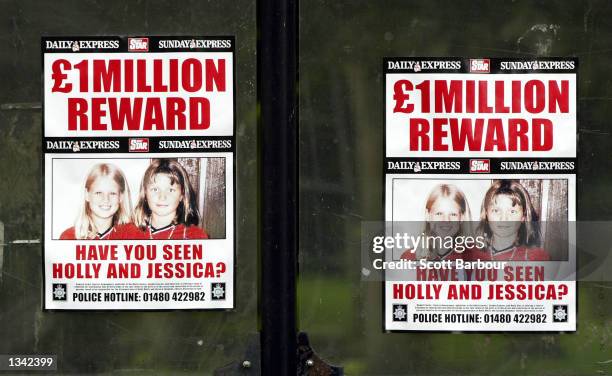 Reward posters for Holly Wells and Jessica Chapman are shown outside St. Andrew's Church August 18, 2002 in Soham, Cambridgeshire, England. The...