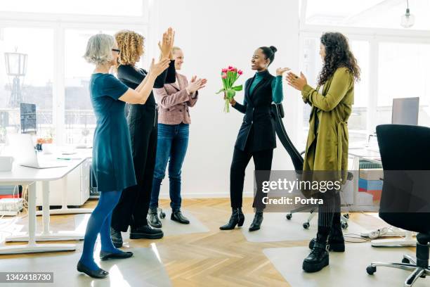 business team applauding for colleague in office meeting - applauding staff stock pictures, royalty-free photos & images