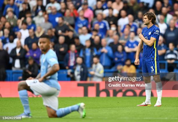 Marcos Alonso of Chelsea points to the say no to racism badge on his shirt as other players take the knee in support of the Black Lives Matter...