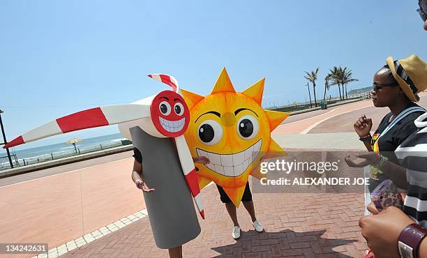 Greenpeace activists try to promote the use of renewable energy, using solar and wind power, on November 29, 2011 on the Durban beachfront. UN...