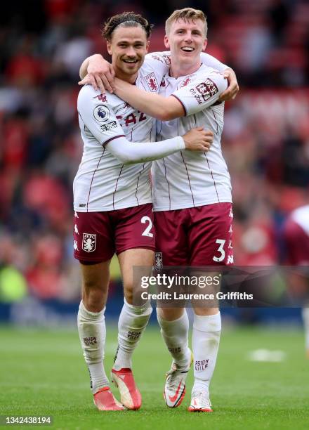 Matty Cash of Aston Villa and Matt Target of Aston Villa celebrate following the Premier League match between Manchester United and Aston Villa at...