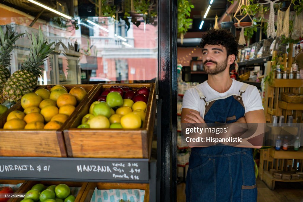 Man working at a local supermarket and waiting for clients