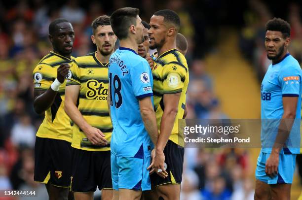 William Troost-Ekong of Watford FC clashes with Federico Fernandez of Newcastle United during the Premier League match between Watford and Newcastle...