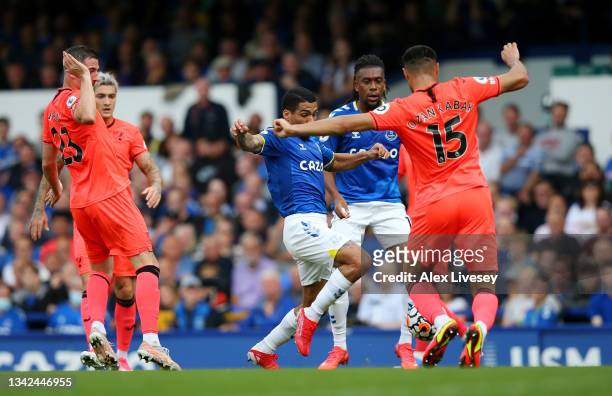 Ozan Kabak of Norwich City fouls Allan of Everton to concede a penalty during the Premier League match between Everton and Norwich City at Goodison...
