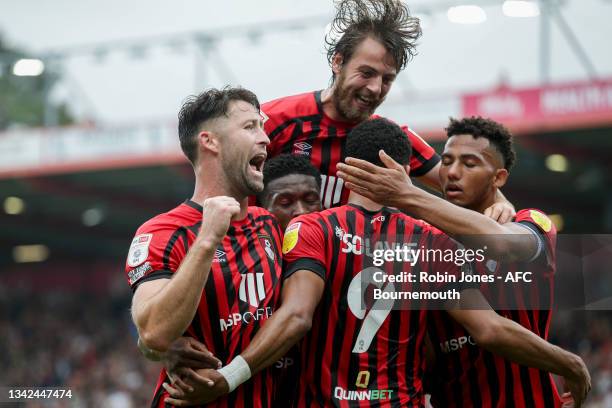 Gary Cahill, Ben Pearson and Lloyd Kelly congratulate team-mate Dominic Solanke of Bournemouth after he heads in and scores a goal to make it 2-0...