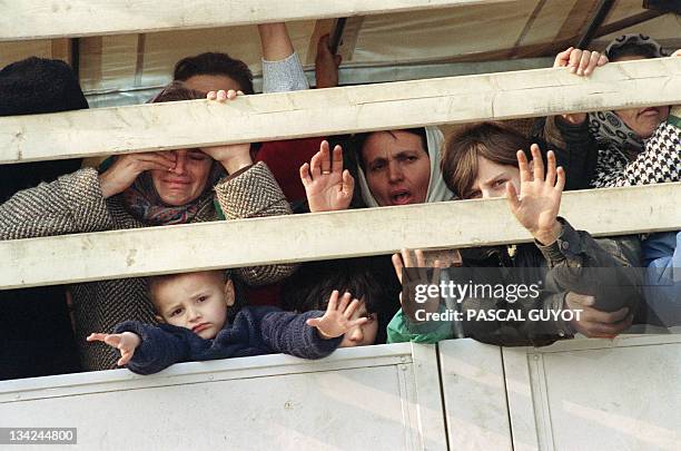 Moslem refugees ride a United Nations truck in a UN convoy as they flee the Serb-besieged Bosnian enclave of Srebrenica for Tuzla 31 March 1993. More...