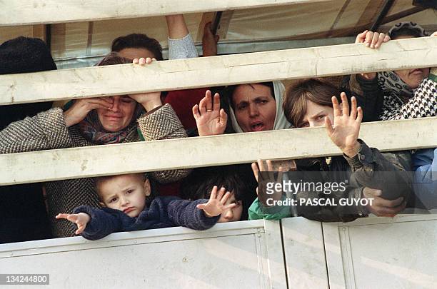 Moslem refugees ride a United Nations truck in a UN convoy as they flee the Serb-besieged Bosnian enclave of Srebrenica for Tuzla 31 March 1993. More...