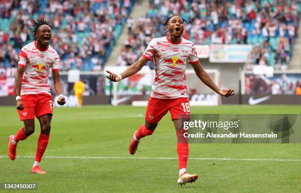 Christopher Nkunku of RB Leipzig celebrates after scoring their team's fifth goal with Mohamed Simakan during the Bundesliga match between RB Leipzig...