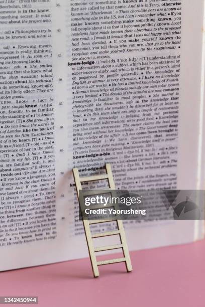 concept photo: ladder up for learning new knowledge with english dictionary - english language bildbanksfoton och bilder