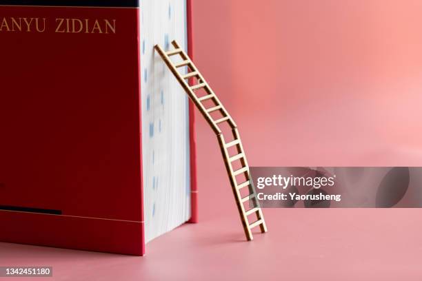 ladder up stack of books,knowledge learning concept - chinese dictionary foto e immagini stock