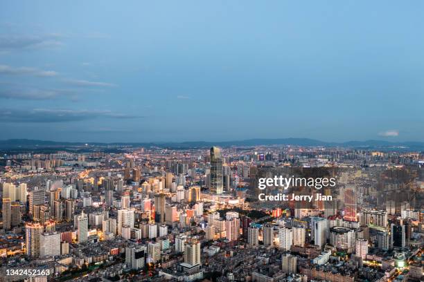 kunming moder cityscape at sunset by air drone - kunming stock-fotos und bilder