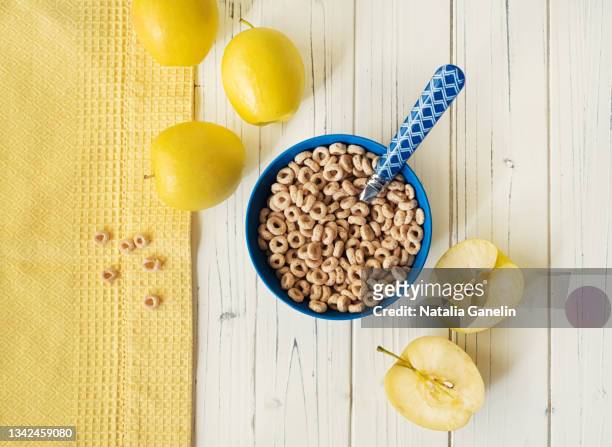 bowl of breakfast cereal and some apples - cheerios stock-fotos und bilder