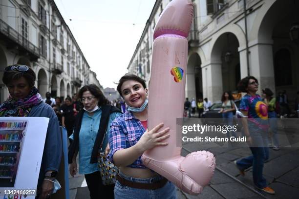 Girl holds a giant penis during the Pride on September 25, 2021 in Turin, Italy. The LGBTQ + community organizes a Pride march after the cancellation...