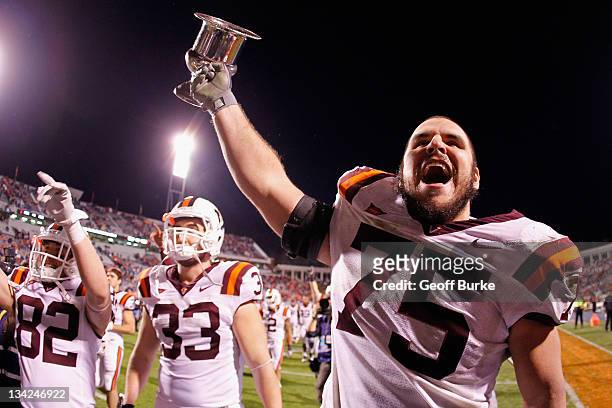 Greg Nosal of the Virginia Tech Hokies and Chris Drager of the Hokies celebrate with the Commonwealth Cup after the Hokies' game against the Virginia...