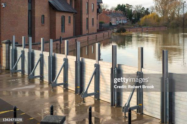 demountable flood barrier in operation during winter flooding from the river severn. - shrewsbury england stock pictures, royalty-free photos & images