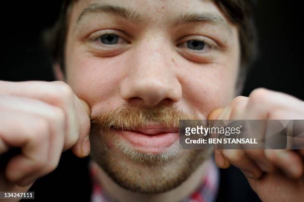 Kris Dorward, a 22 year-old chef, poses for pictures with his 'Movember moustache' in London, on November 28, 2011. From the pencil-thin version...