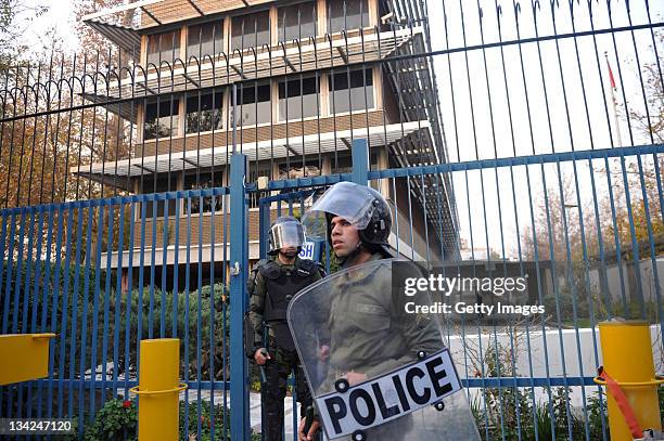 Police in riot gear guard a gate following a break in by protesters at the British Embassy during an anti-British demonstration in the Iranian...