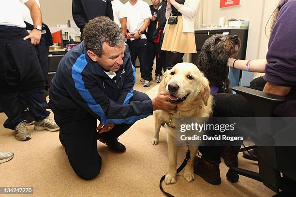 Wayne Smith, the assitant coach of the Southern Hemisphere team is shown one of the dog partners who are trained to be of assitance to injured...