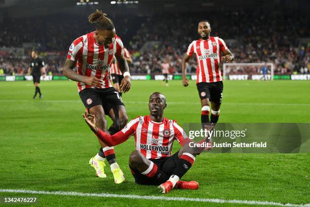 Yoane Wissa of Brentford celebrates scoring his sides third goal with Ivan Toney and Rico Henry during the Premier League match between Brentford and...