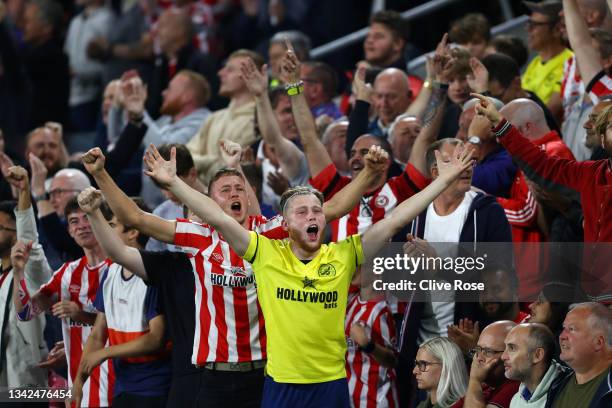 Brentford fans cheer on their team during the Premier League match between Brentford and Liverpool at Brentford Community Stadium on September 25,...