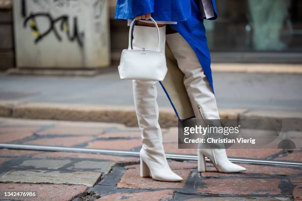 Karina Nigay seen wearing blue asymmetric skirt, blazer, white button shirt, boots outside Ermanno Scervino during the Milan Fashion Week - Spring /...