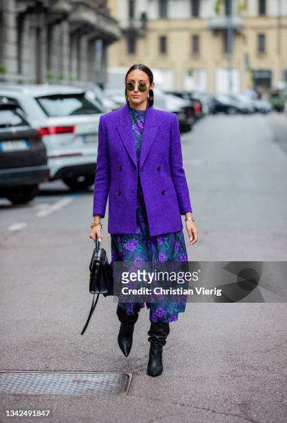 Elisa Taviti seen wearing purple blazer, dress with print outside Salvatore Ferragamo during the Milan Fashion Week - Spring / Summer 2022 on...