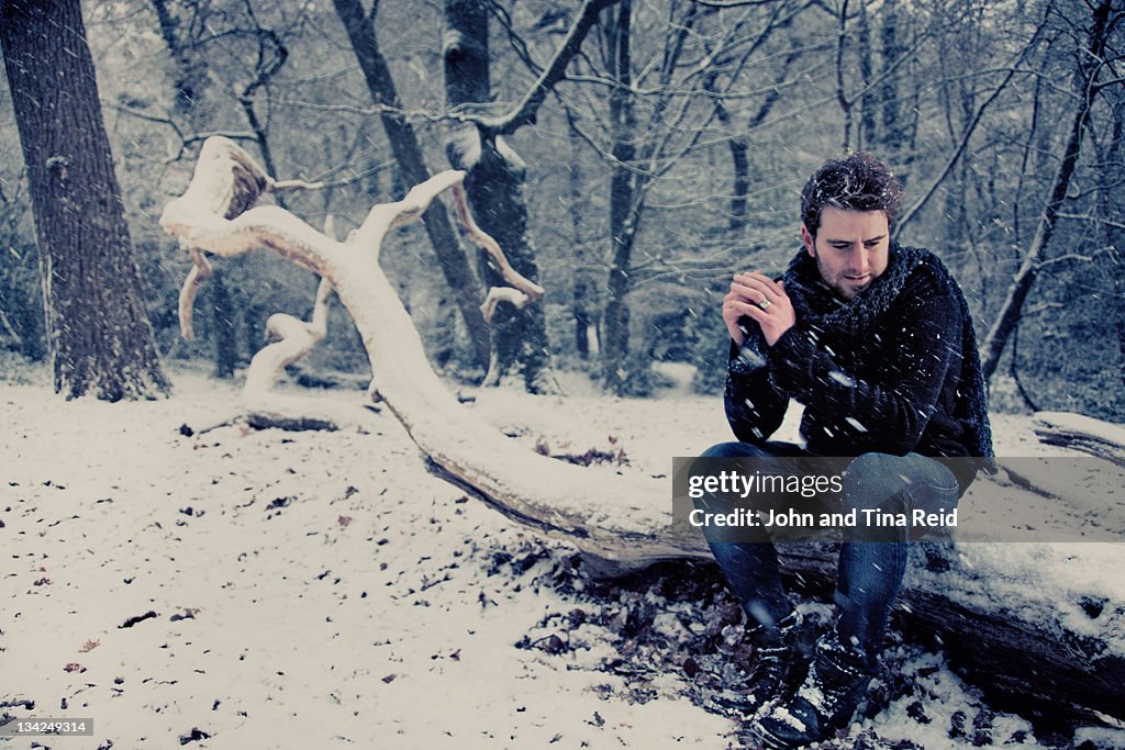 Man sitting on tree trunk