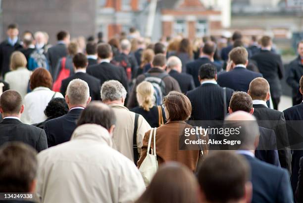 crowd of commuters - crowd of people stock pictures, royalty-free photos & images