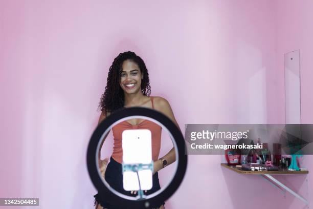 black young woman filming herself dancing at home to share on social media - clip stock pictures, royalty-free photos & images