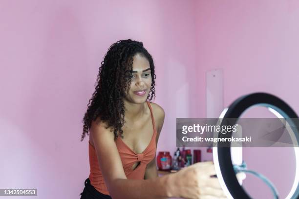 black young woman filming herself dancing at home to share on social media - youtube tiktok stock pictures, royalty-free photos & images
