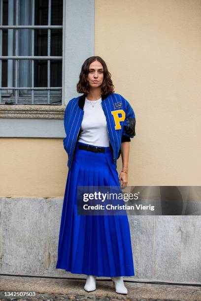 Erika Boldrin seen wearing blue pleated skirt and striped baseball jacket outside Philosophy during the Milan Fashion Week - Spring / Summer 2022 on...