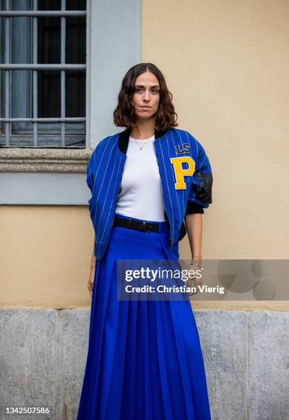 Erika Boldrin seen wearing blue pleated skirt and striped baseball jacket outside Philosophy during the Milan Fashion Week - Spring / Summer 2022 on...