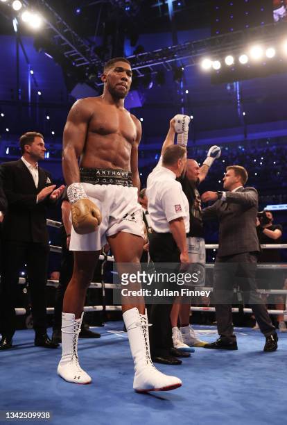 Anthony Joshua cuts a dejected figure as Oleksandr Usyk celebrates after being crowned the new World Champion following the Heavyweight Title Fight...