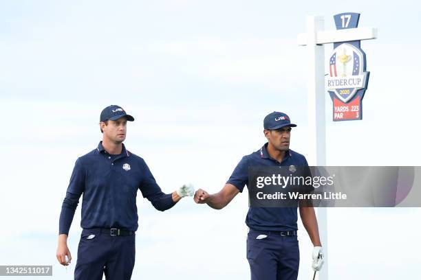 Harris English of team United States and Tony Finau of team United States fist bump on the 17th tee during Saturday Afternoon Fourball Matches of the...