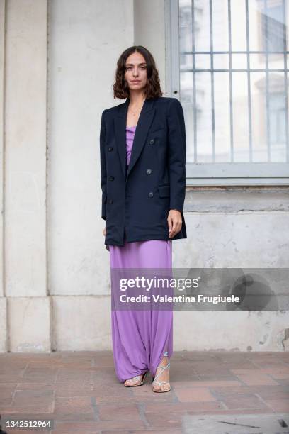 Erika Boldrin outside Salvatore Ferragamo fashion show wearing a purple satin dress and black jacket during the Milan Fashion Week - Spring / Summer...