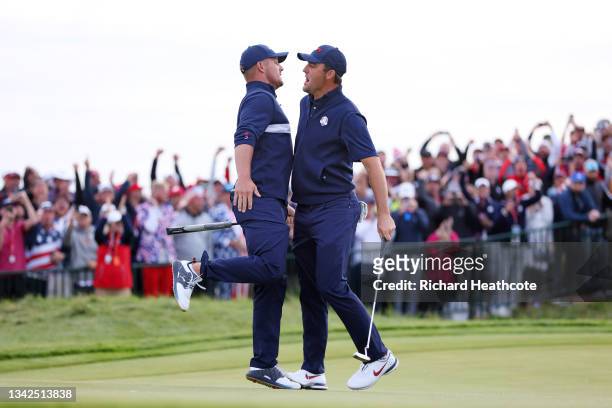 Bryson DeChambeau of team United States and Scottie Scheffler of team United States celebrate on the 15th green during Saturday Afternoon Fourball...