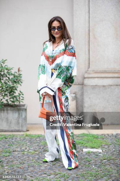 Giulia Gaudino outside Philosophy fashion show wearing a satin printed shirt and pants, orange bag and green heels during the Milan Fashion Week -...