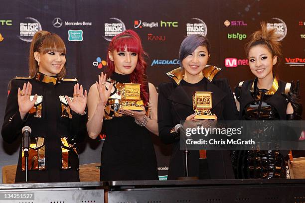 Winners of The Best Song Award, 2NE1 pose with their trophy during the 2011 Mnet Asian Music Awards winners press conference at Marina Bay Sands on...