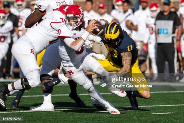 Quarterback Noah Vedral of the Rutgers Scarlet Knights evades defensive end Braiden McGregor of the Michigan Wolverines in the second quarter at...