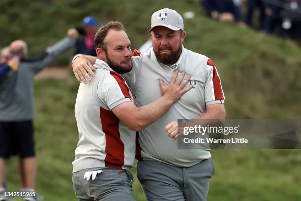 Shane Lowry of Ireland and team Europe and Tyrrell Hatton of England and team Europe celebrate their 1up win over Harris English of team United...