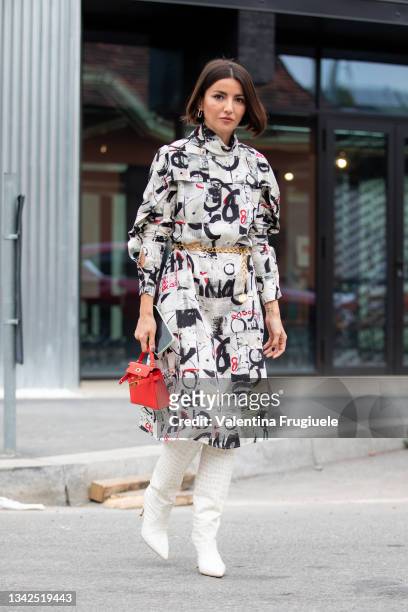 Alexandra Pereira outside Ports 1961 fashion show waring a white printed dress and withe crocodile boots and a red Hermes mini bag during the Milan...
